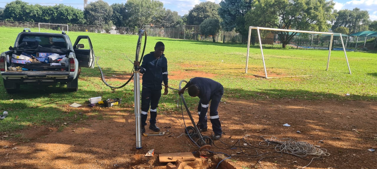 Marz technicians installing a submersible borehole pump